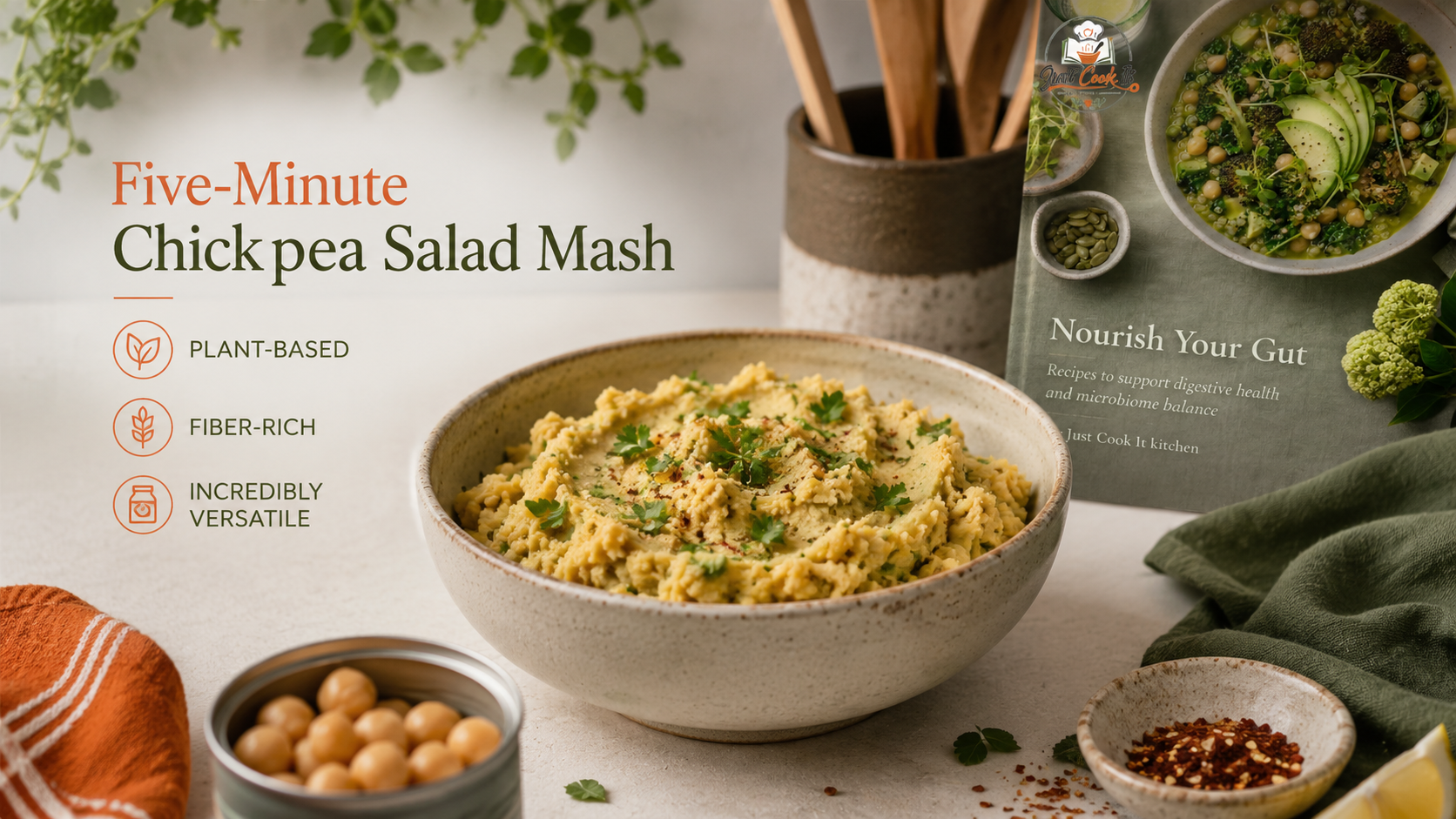 A creamy chickpea salad mash in a textured bowl, garnished with herbs, surrounded by fresh ingredients and a recipe card, highlighting its plant-based and fiber-rich qualities.